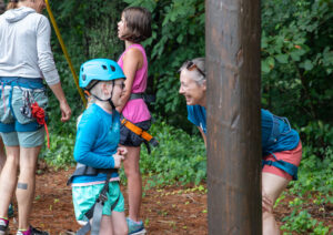 Children in the local BRAVO program get ready to climb the alpine tower.