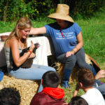 Student teaching children outdoors