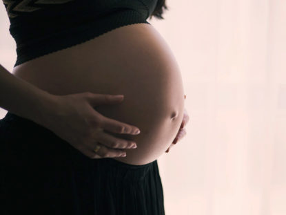 A close-up shot of a pregnant belly