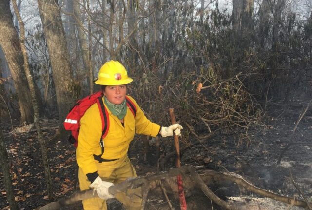 Junior Melina Lozano works on a fire off Bee Tree Road in Swannanoa last November.