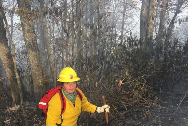 Junior Melina Lozano works on a fire off Bee Tree Road in Swannanoa last November.