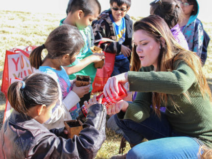 Student works with children at Pine Ridge