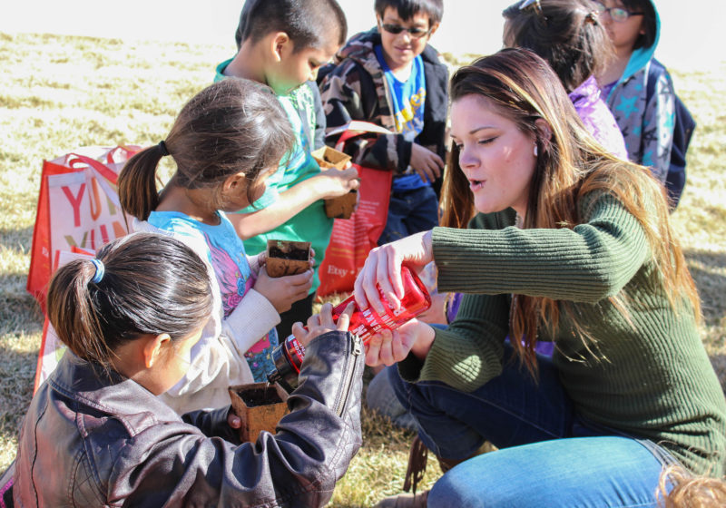 Student works with children at Pine Ridge