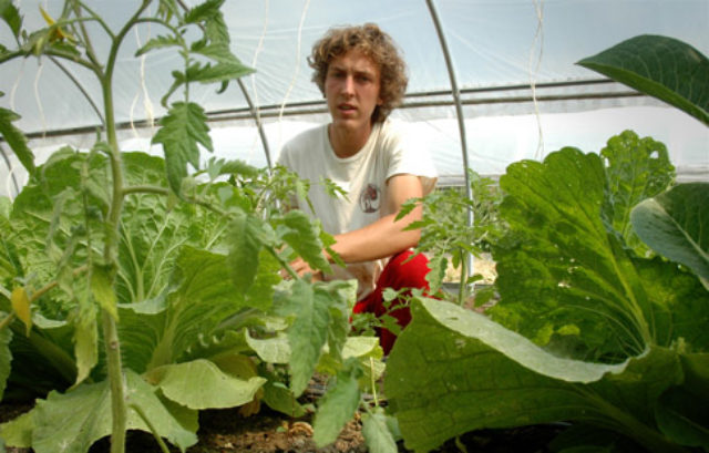 Watters takes a hands-on approach to his sustainable agriculture studies by working in the college garden.