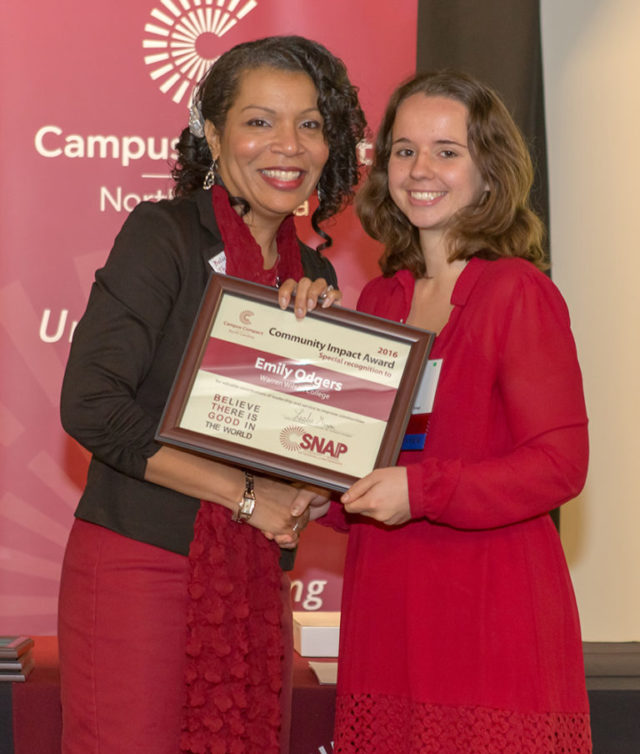 Warren Wilson College senior Emily Odgers receives the 2016 Community Impact Award from Leslie Garvin, executive director of North Carolina Campus Compact.