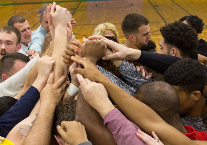 Hands together in a huddle