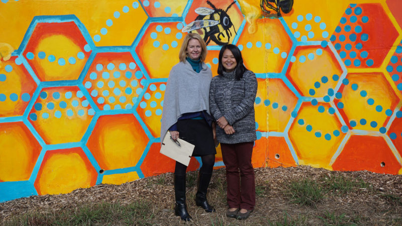 Lynn Morton and Lara Nguyen in front of mural