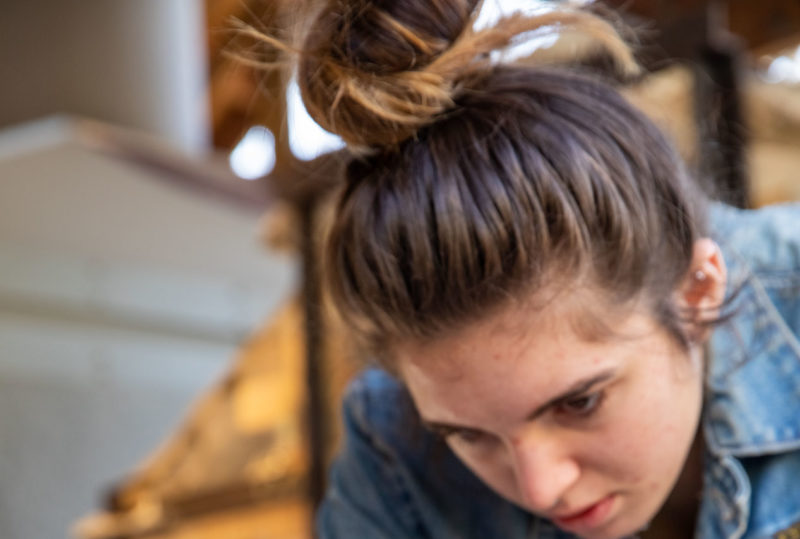 Art student decorating a pot