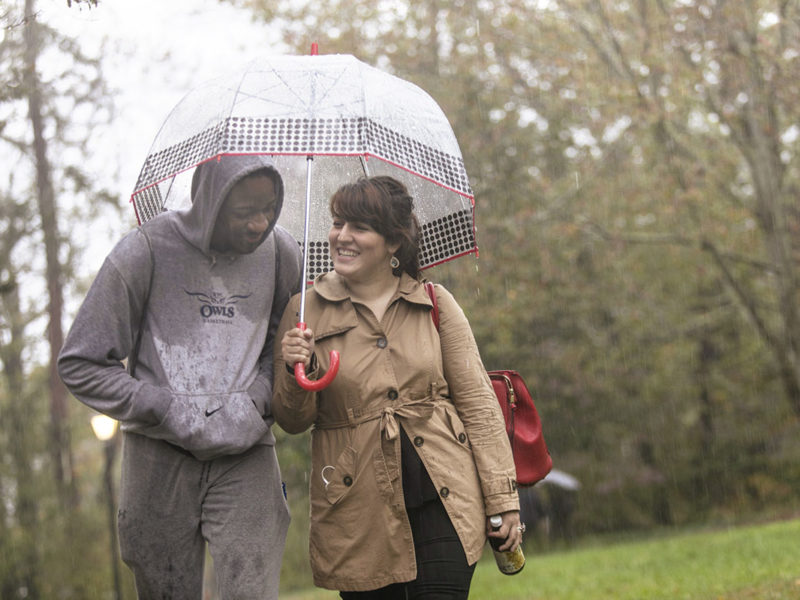 Students walk in the rain