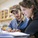 students collaborate on computer