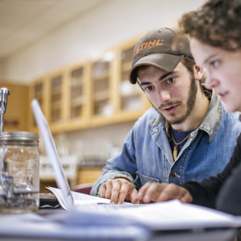 students collaborate on computer