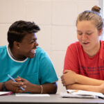 An incarcerated student works with a Warren Wilson student