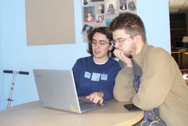 A Writing Studio Crew Student helping a student with their writing.