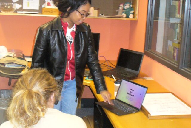 A Writing Studio Crew Student helping a student with their writing.