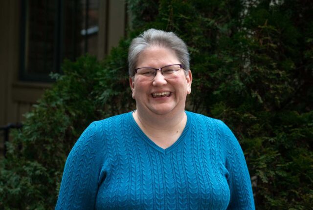 Dean of Students Tacci Smith stands smiling.