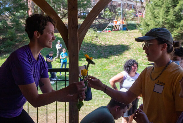 The Queer Resource Center Crew handing out flowers on Work Day.