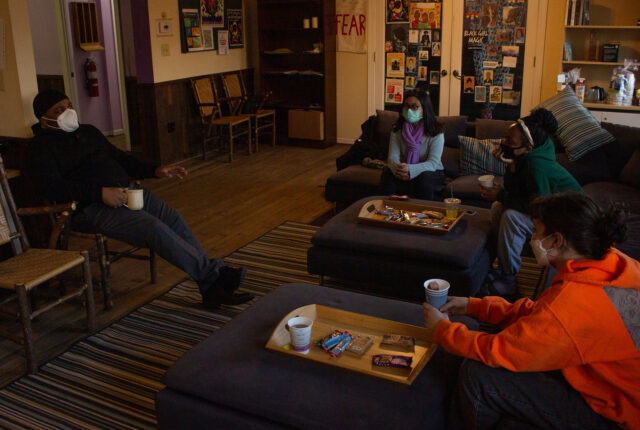 WIDE Crew Students hosting a tea and talk event sitting on couches