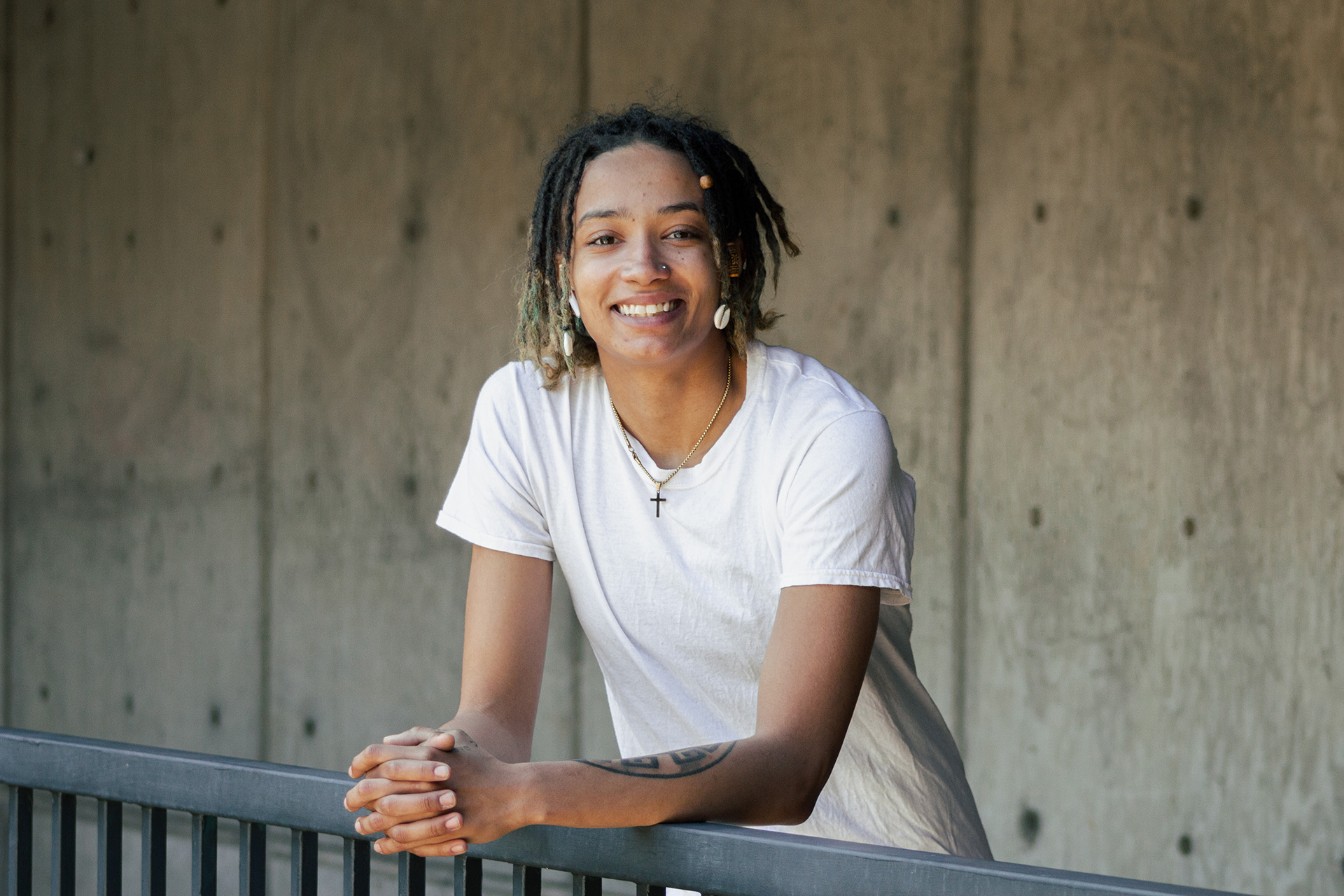 WWC Alum Daymón Hinkelman stands smiling for his portrait.