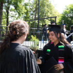 Anna Welton presents a tree to a graduate