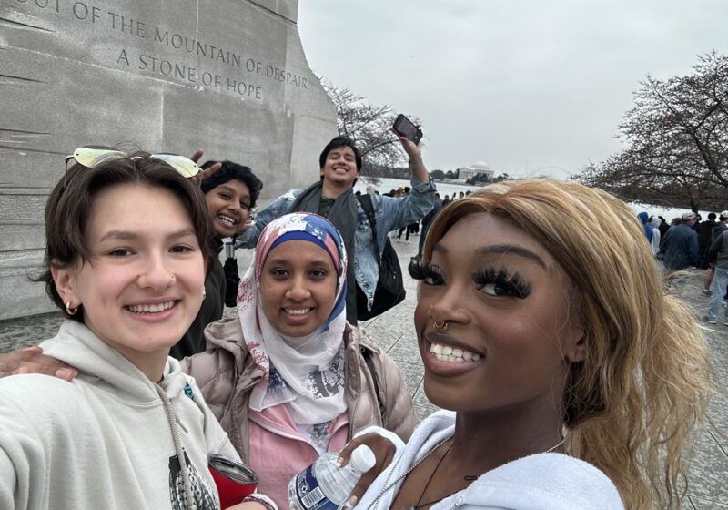 Students in the Engage living and learning community pose and smile at the Martin Luther King Jr. Memorial in Washington D.C.