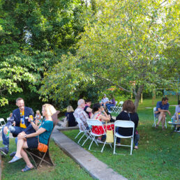 Parents gather at tables and chat at a family weekend event.
