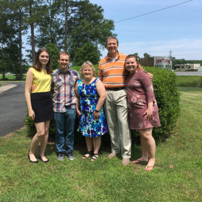 Christopher Potvin standing for a group photo with family and friends