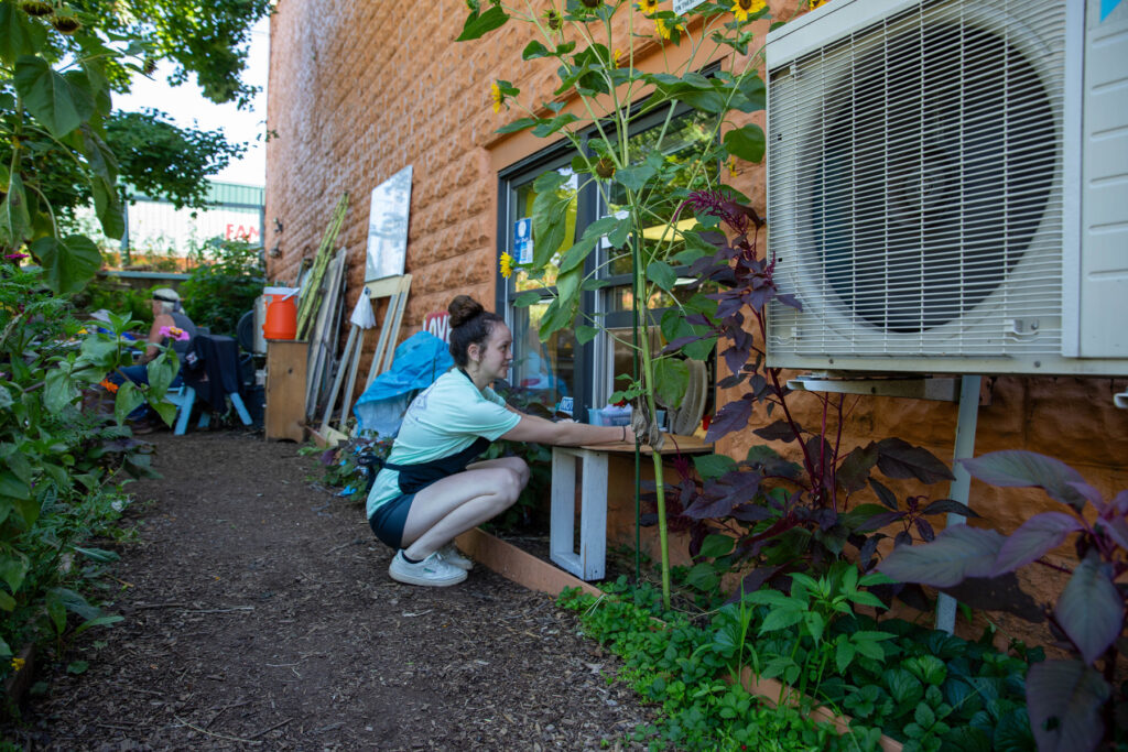 A Warren Wilson College student grabs food from the serving window at 12 baskets cafe to serve food to locals in need. 
