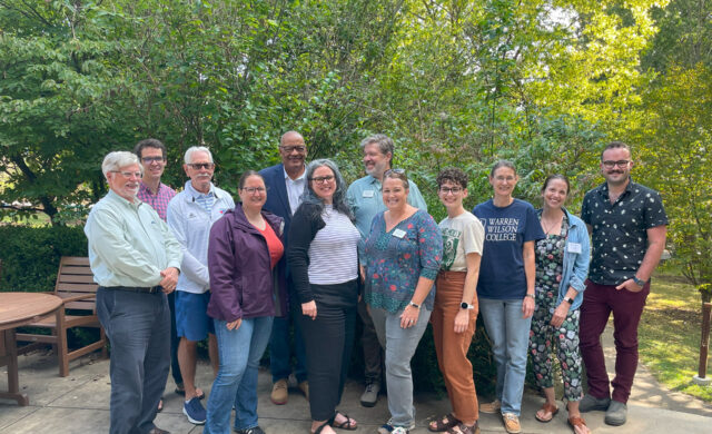 The 2023 Alumni Board stand and smile for a photo.