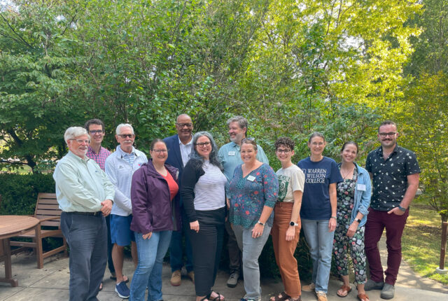 The 2023 Alumni Board stand and smile for a photo.