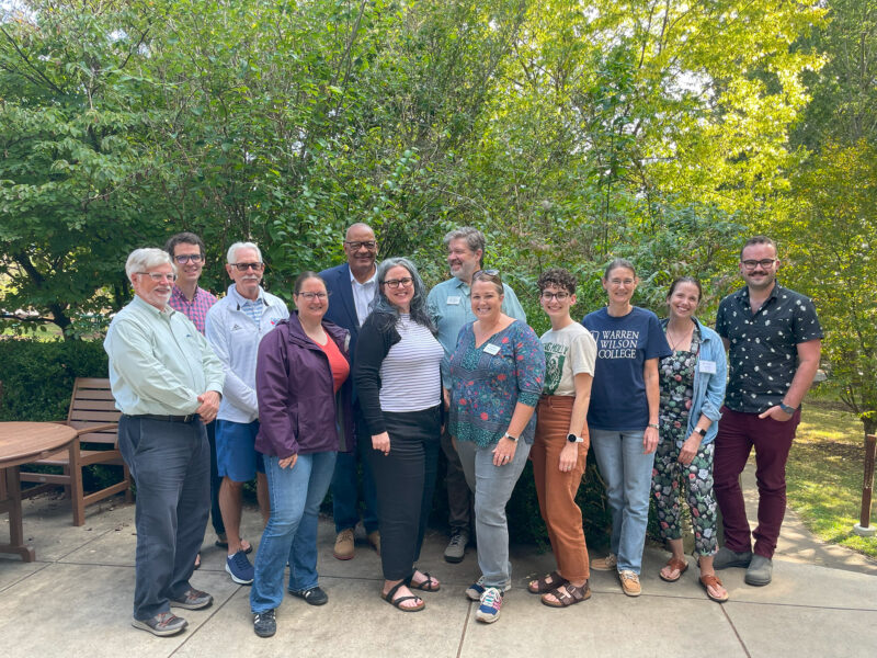 The 2023 Alumni Board stand and smile for a photo.