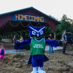 The owl mascot stands in front of the homecoming barn