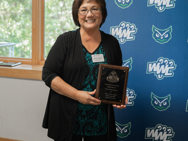 Distinguished Service Award Recipient Rowena Pomeroy stands smiling with her plaque.