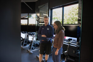 Psychology Professor Bob Swoap shows alum Marisa Romeo data on his computer.