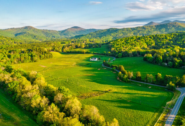 An aerial photo of the white barn and pastures