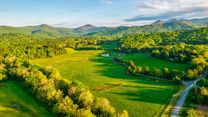 An aerial photo of the white barn and pastures