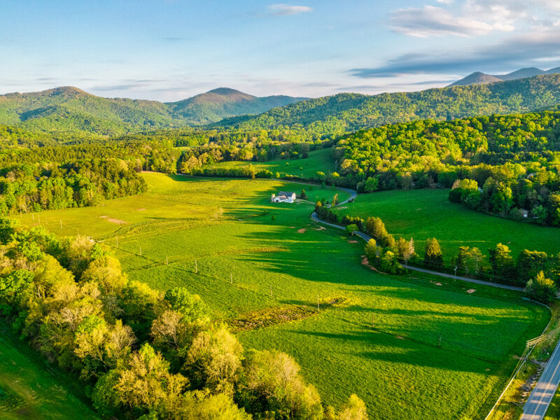 An aerial photo of the white barn and pastures