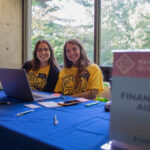 The financial aid team mans their table at new student check in.