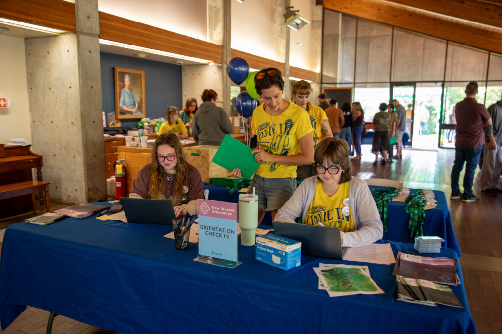 Student leaders check students in for move in