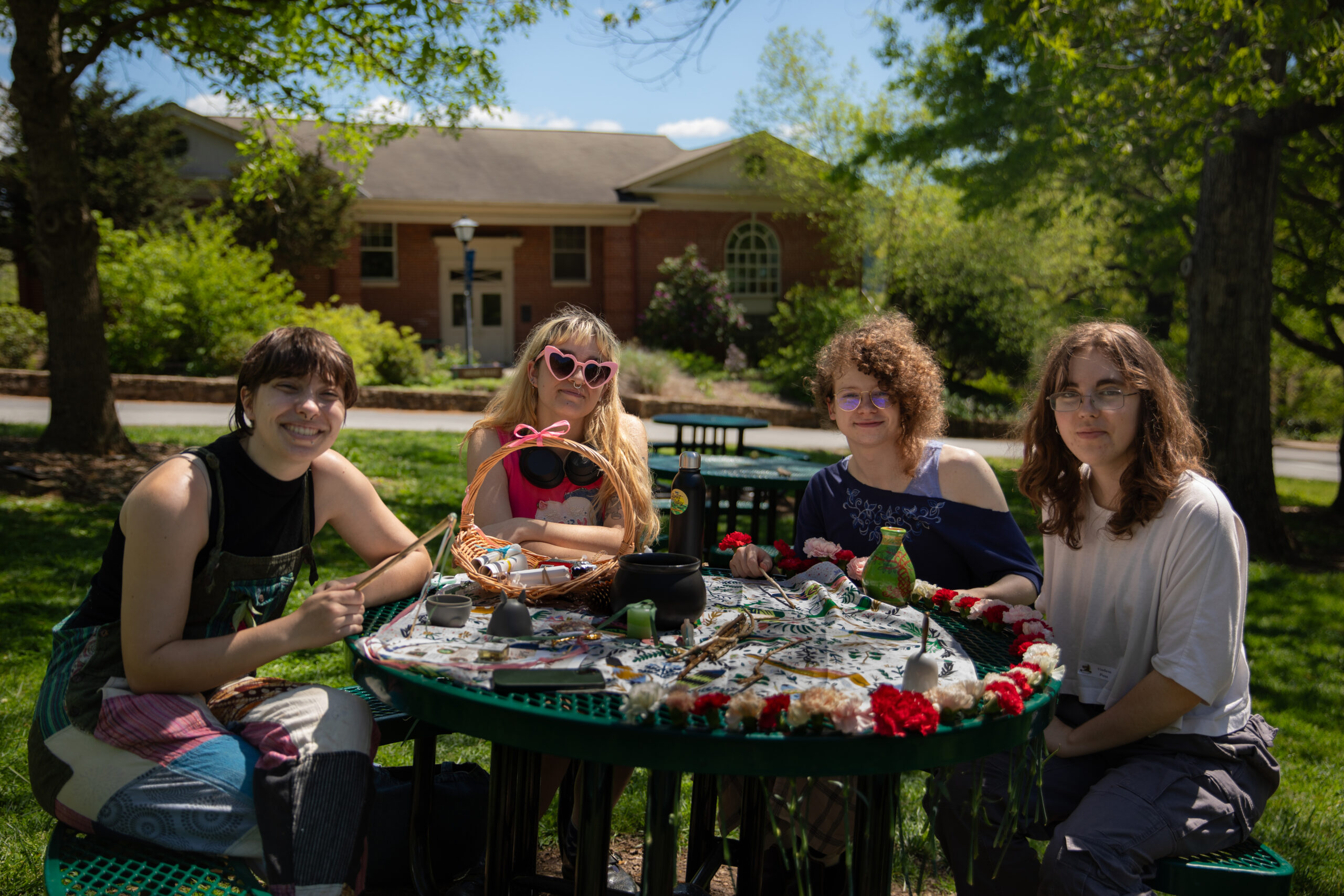 The Merry Pagans celebrate Beltane crafting on cowpie lawn.