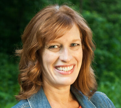 Dr. Melissa Booth stands smiling for a headshot photo.