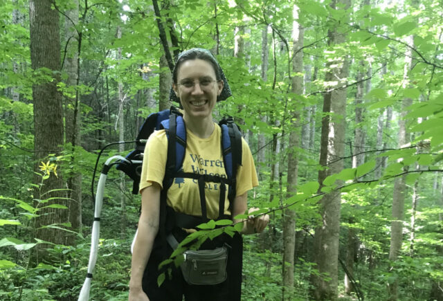 student in the forest studying endophytes