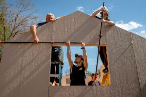 students work on tiny home construction