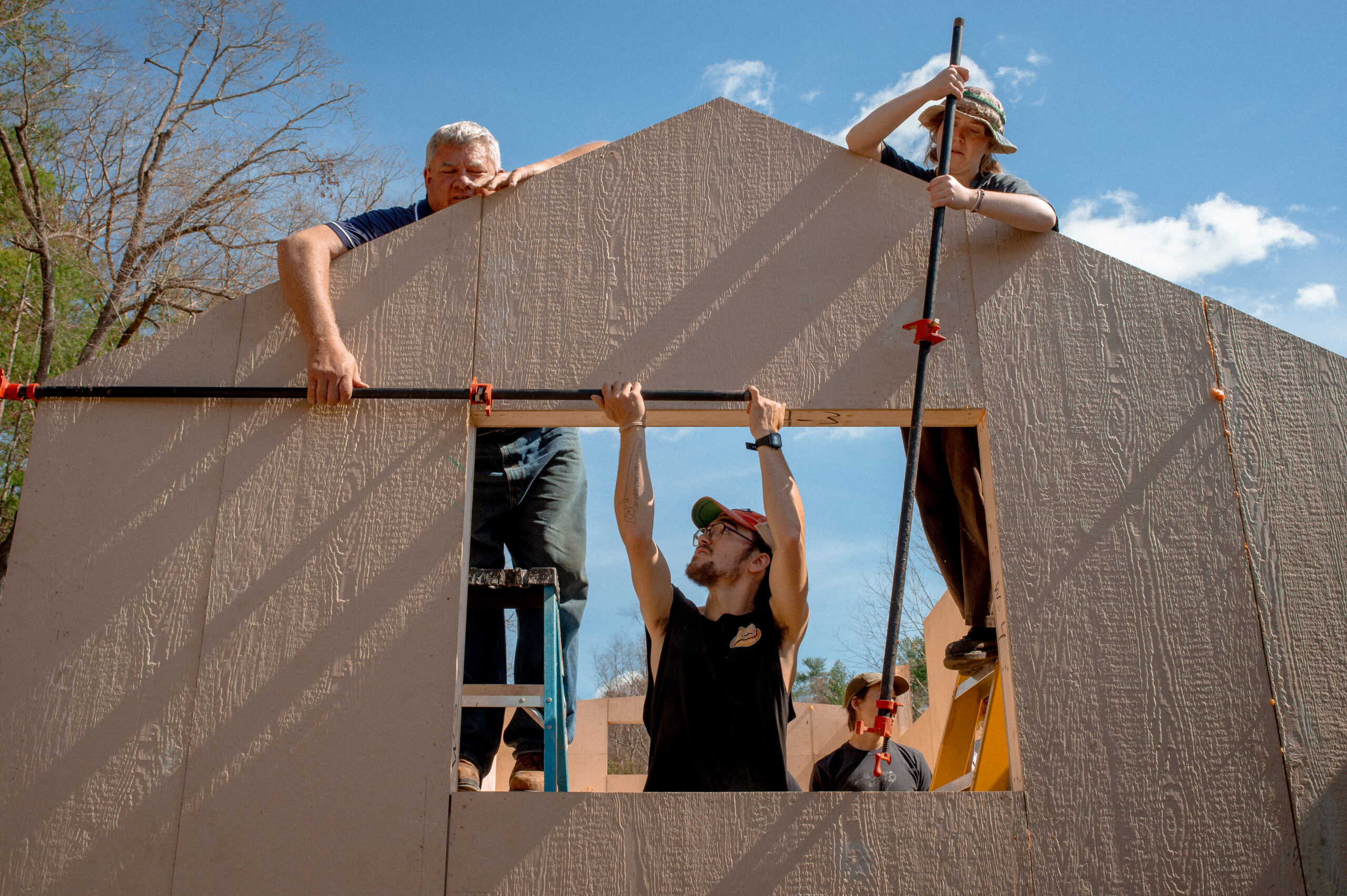 students work on tiny home construction