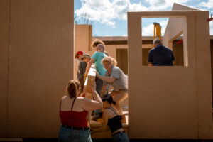 students work on tiny home construction