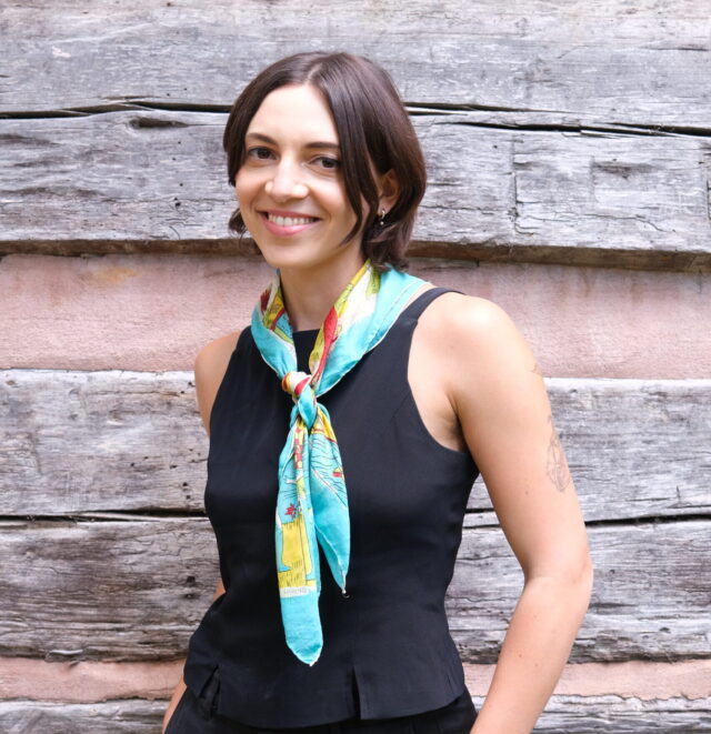 Visiting Assistant Professor of English and Communication Sarah Sgro stands smiling for a picture.