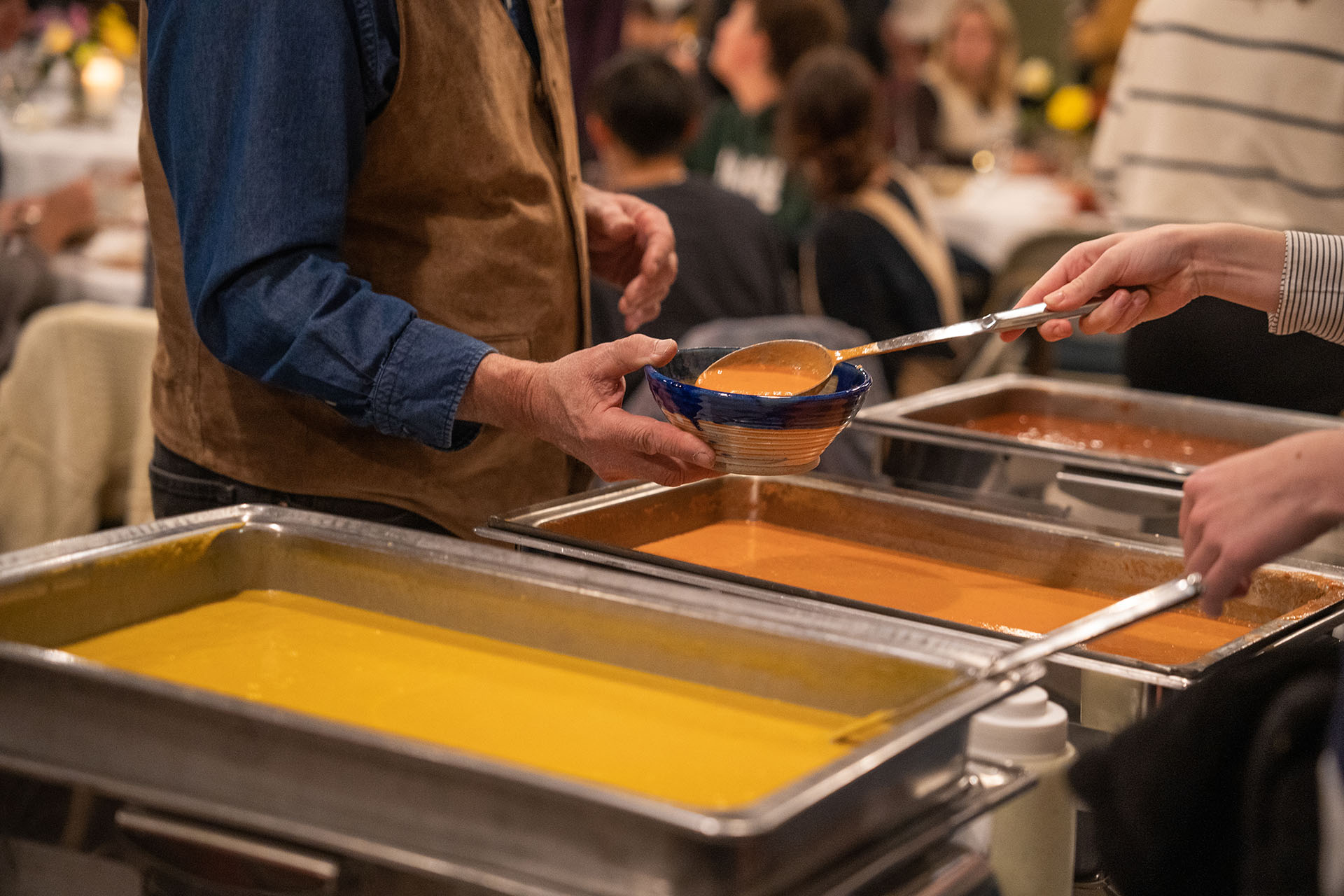 Students serve the community at the annual empty bowls dinner.