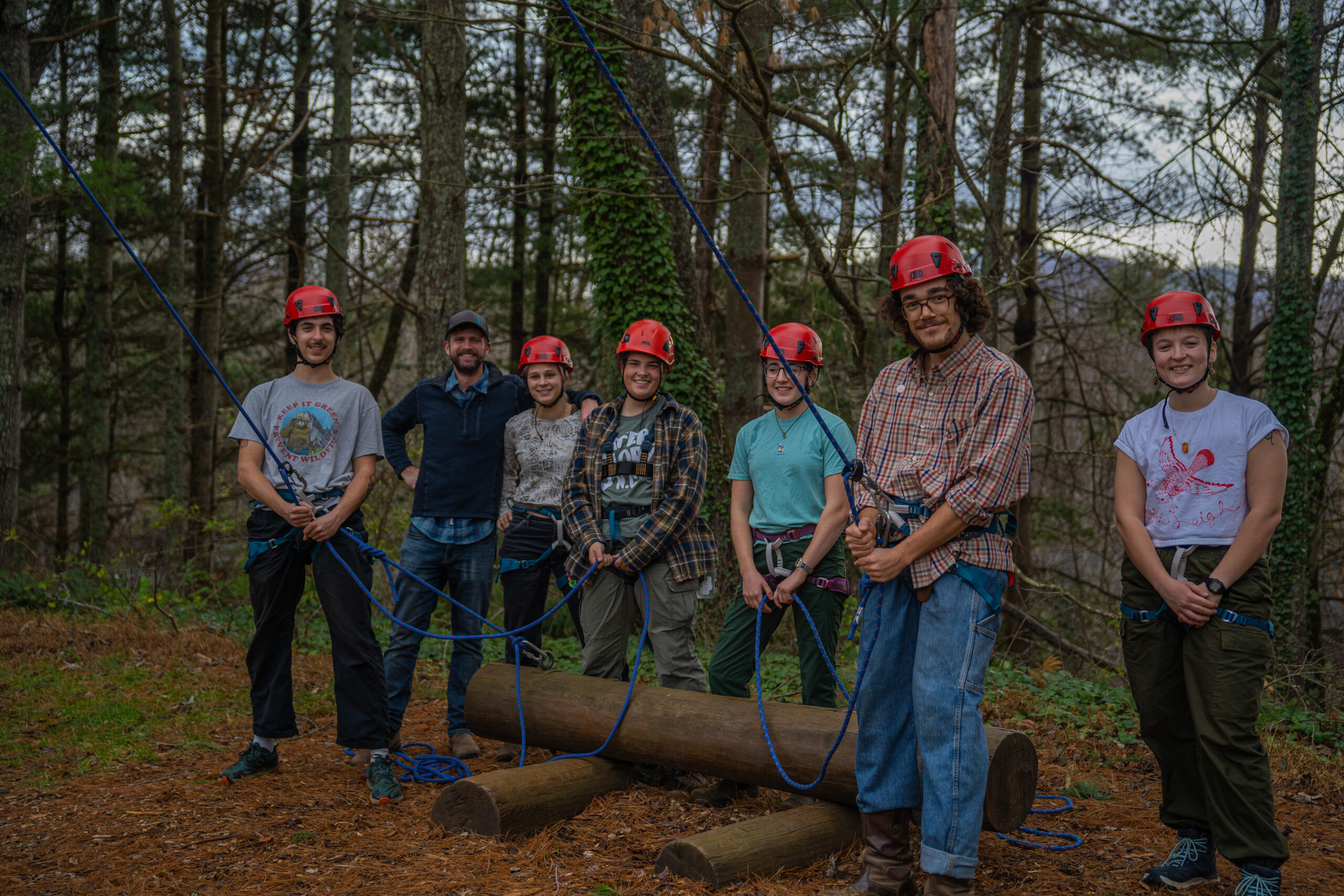 Students stand at the base of the alpine tower on campus