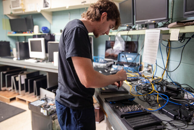 An ITS student works on a laptop.