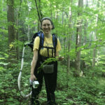 student in the forest studying endophytes