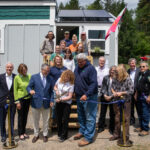 WWC Student Maeve Williams cutting the ribbon at the Tiny Home dedication ceremony